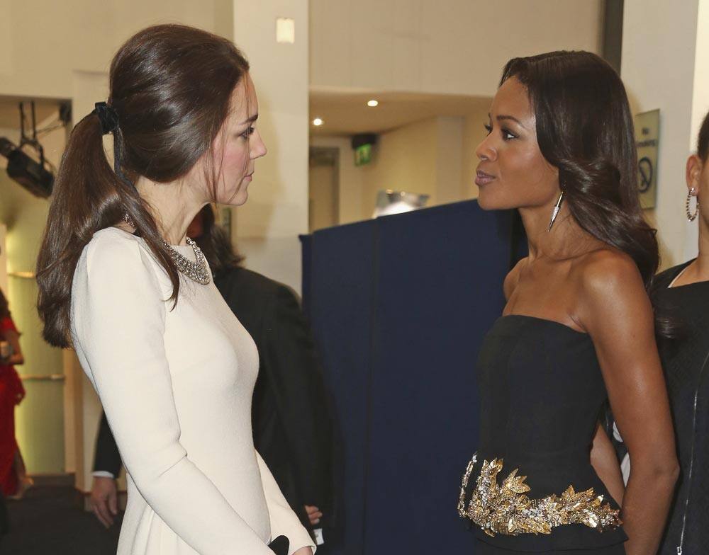 Britain's Kate, Duchess of Cambridge speaks to actress Naomie Harris during the UK premiere of the movie 