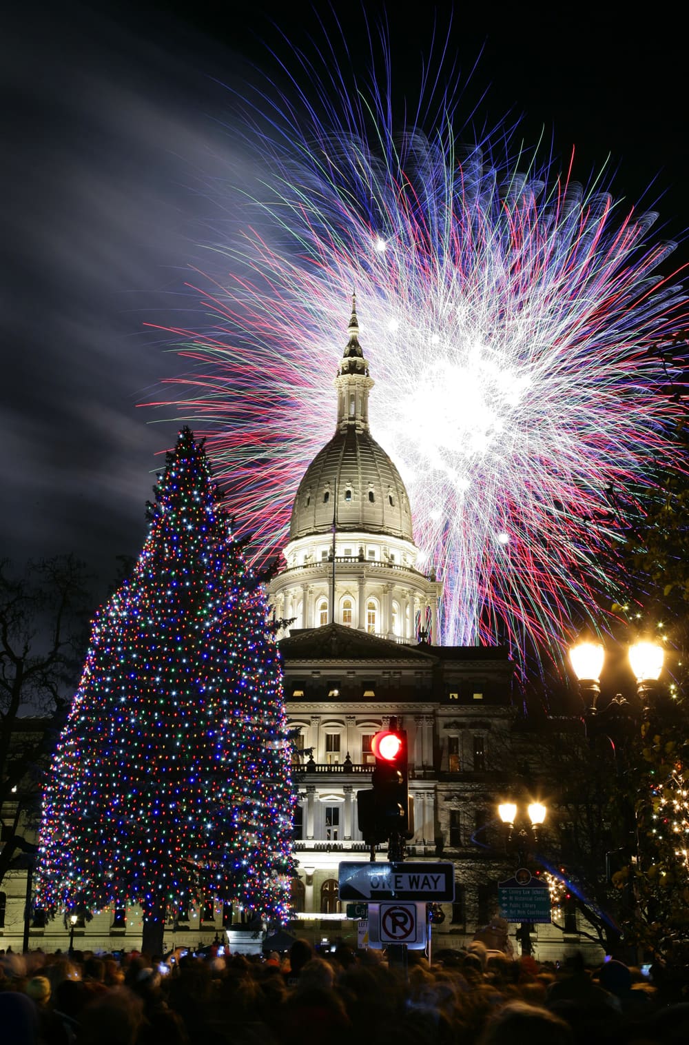 Fireworks explode over the state Capitol following a ceremony lighting the official state Christmas tree in Lansing, Mich.