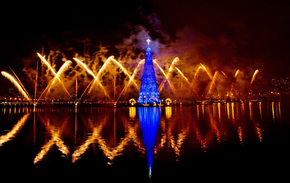 Fireworks explode over a floating Christmas tree in Lagoa lake at the annual holiday tree lighting event in Rio de Janeiro, Brazil.