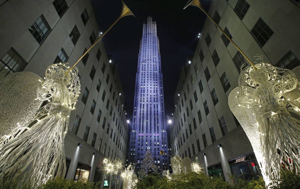 Angels made of wire and light frame the Rockefeller Center Christmas tree after it was lit during a ceremony in New York.