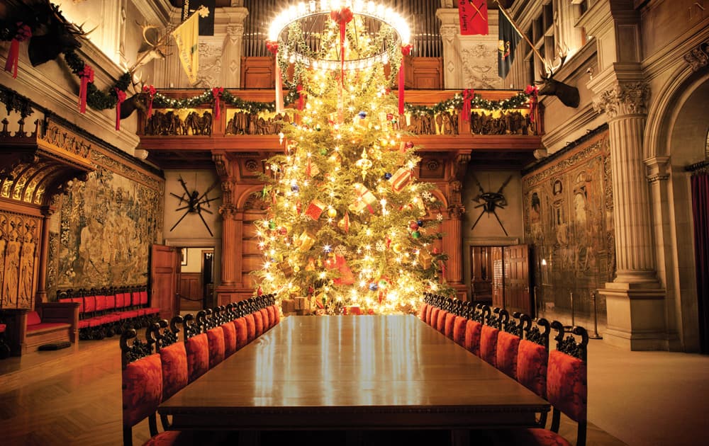 This undated photo provided by the Biltmore in Asheville, N.C., shows the National Historic Landmark’s banquet hall decorated for Christmas. Holiday displays at the estate will be up through 12th Jan.