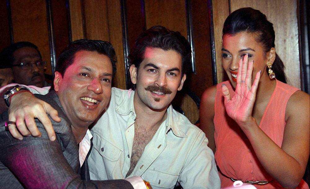 Bollywood actors Neil Nitin Mukesh, Mugdha Godse and director Madhur Bhandarkar during a fashion show in Mumbai.