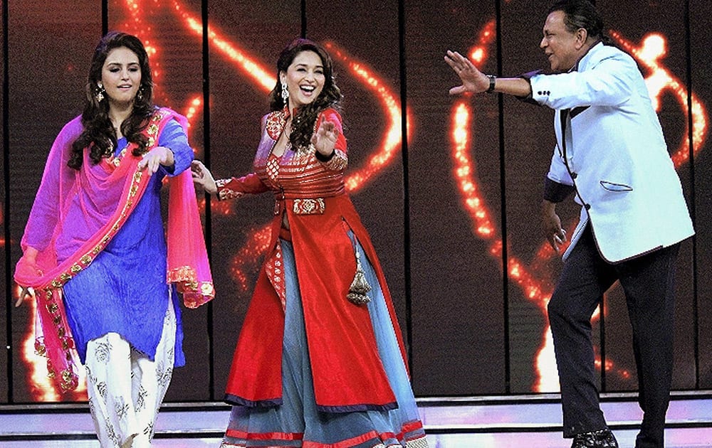 Bollywood actress Madhuri Dixit and Huma Qureshi dance with veteran actor Mithun Chakraborty on the sets of a dance reality show to promote their upcoming movie, in Mumbai.