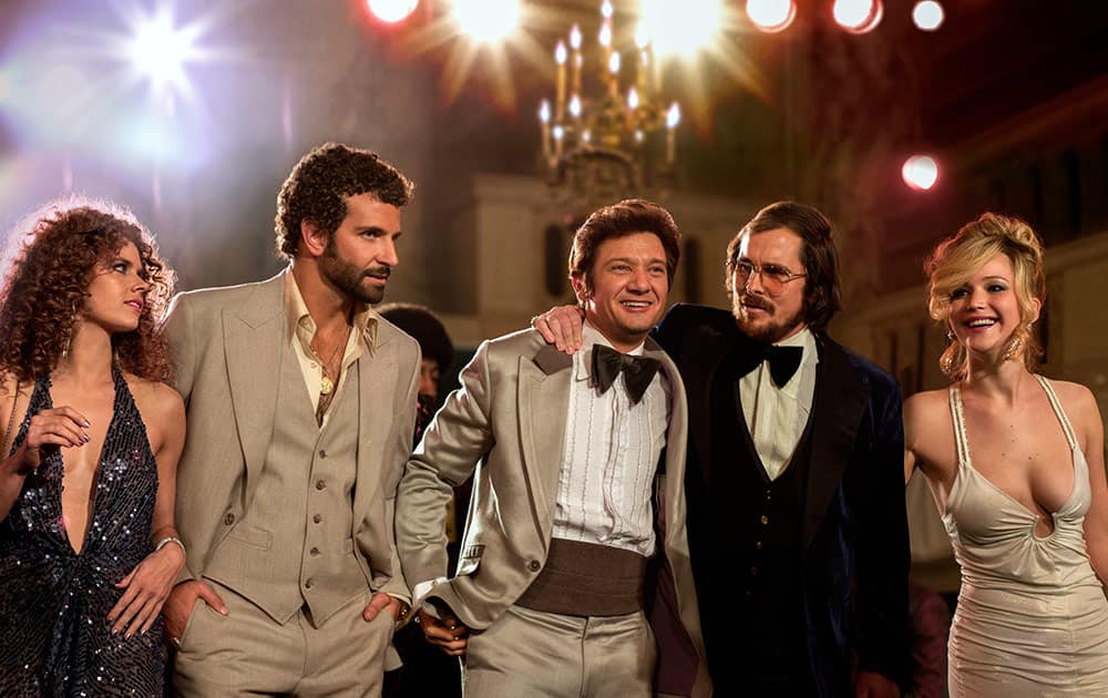 This film image released by Sony Pictures shows, from left, Amy Adams, Bradley Cooper, Jeremy Renner, Christian Bale and Jennifer Lawrence in a scene from `American Hustle.`