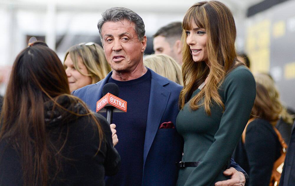 Actor Sylvester Stallone and wife Jennifer Flavin attend the world premiere of `Grudge Match`, benefiting the Tribeca Film Institute, at the Ziegfeld Theatre in New York. 