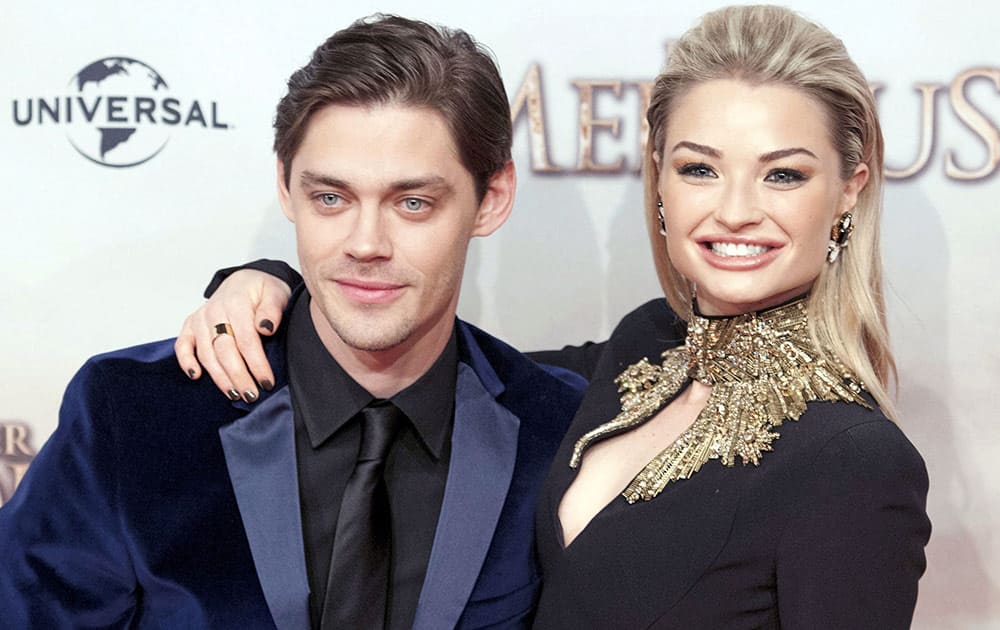 Emma Rigby smiles is she stands with actor Tom Payne during the photo call at the world premiere of 'The Physician' (German title 'Der Medicus') in Berlin, Germany.