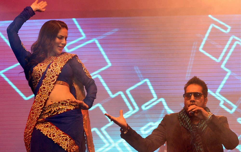 Bollywood actress Sunny Leone performs with singer Mika Singh during a musical concert in Gurgaon.