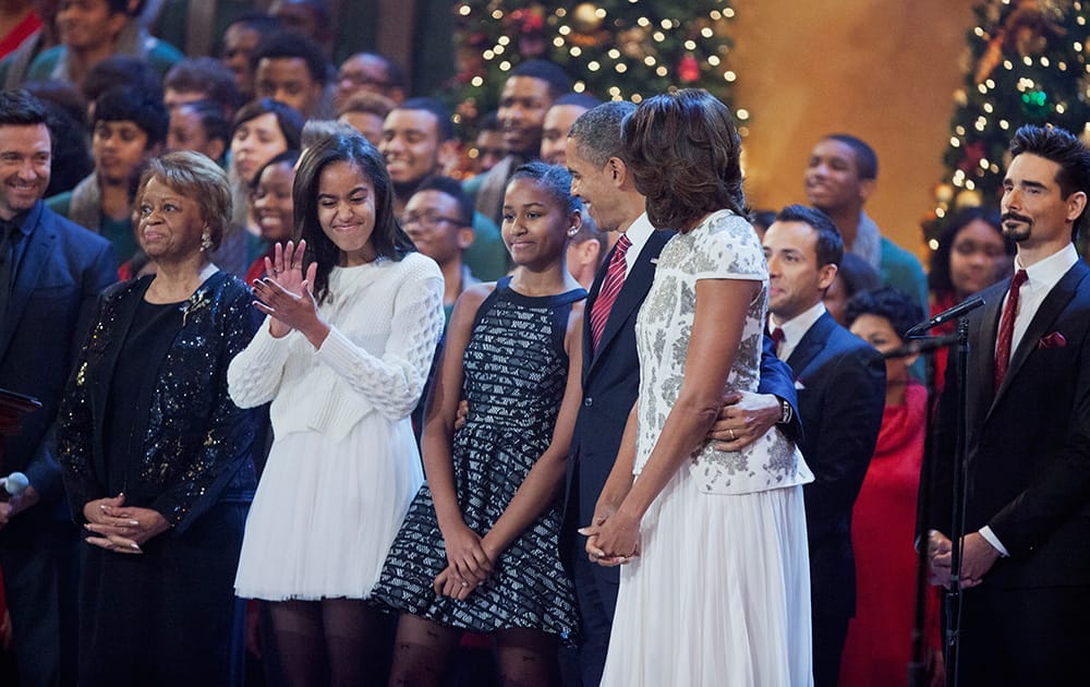 The first family join host Hugh Jackman, Kevin Richardson of the Backstreet Boys and other performers on the stage singing the Christmas carol during the annual 2013 Christmas in Washington presentation at the National Building Museum in Washington.