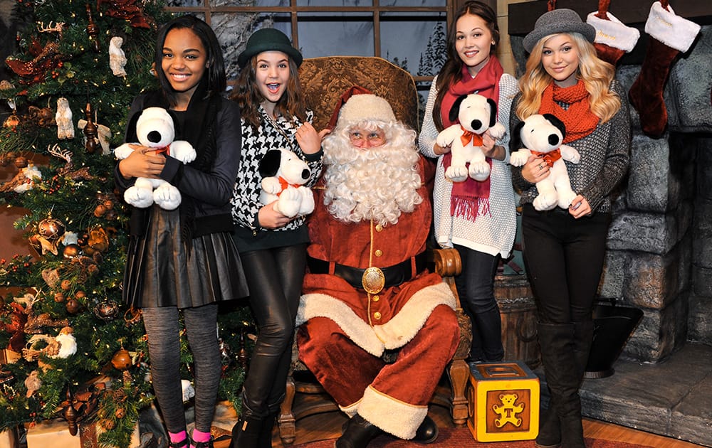 From left, China Anne McClain, Bailee Madison, Santa Claus, Kelli Berglund, and Olivia Holt attend Snoopy's Merriest Tree Lighting at Knott's Berry Farm, in Buena Park, Calif. 