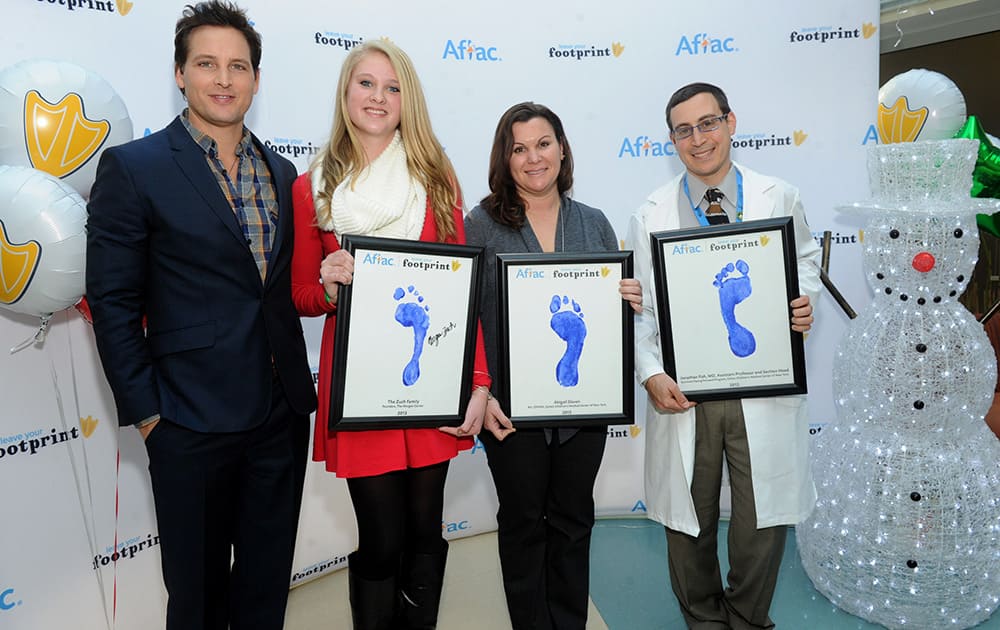 Actor Peter Facinelli, left, presents Aflac Duckprints Awards to cancer survivor Morgan Zuch, 15, Abigail Slaven, RN, and Jonathan D. Fish, MD, left to right, at Cohen Children’s Medical Center, in New Hyde Park, NY.