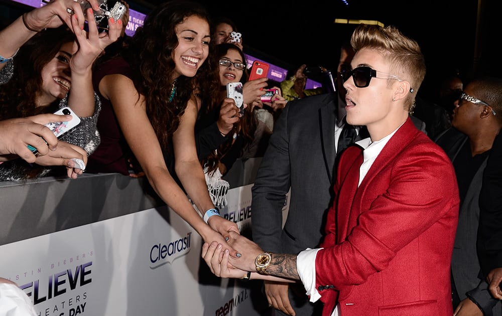 Singer Justin Bieber greets fans at the premiere of the feature film `Justin Bieber's Believe` at Regal Cinemas L.A. Live in Los Angeles.