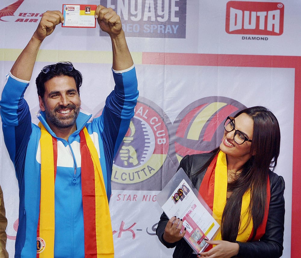 Akshay Kumar showing his life time membership of East Bengal Club as Sonakshi Sinha looks on in Kolkata on Friday on the eve of Pre-Centenary Star night celebrations.