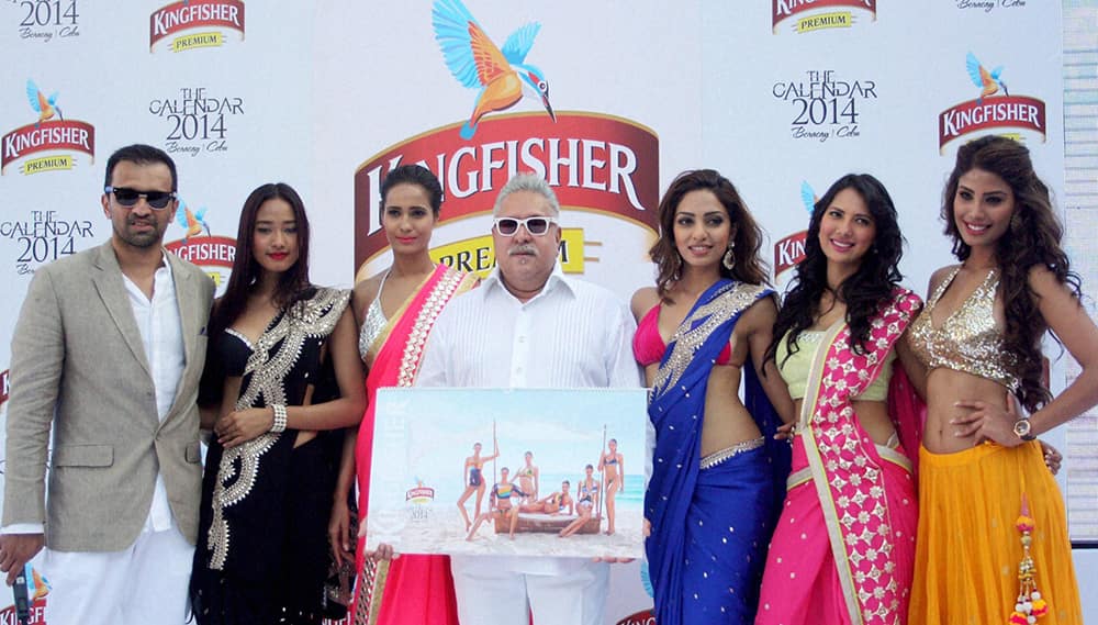 Vijay Mallya, Chairman of UB Group with models during the launch of Kingfisher Calendar 2014 at Kingfisher House near Alibaug, Maharashtra.