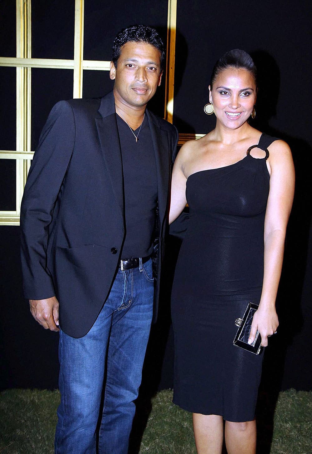 Bollywood actress Lara Dutta poses with her husband tennis player Mahesh Bhupathi as they arrive to attend a party hosted by actress Deepika Padukone in Mumbai.