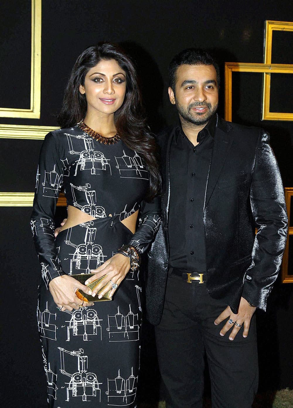 Bollywood actress Shilpa Shetty poses with her husband Raj Kundra as they arrive to attend a party hosted by actress Deepika Padukone in Mumbai.