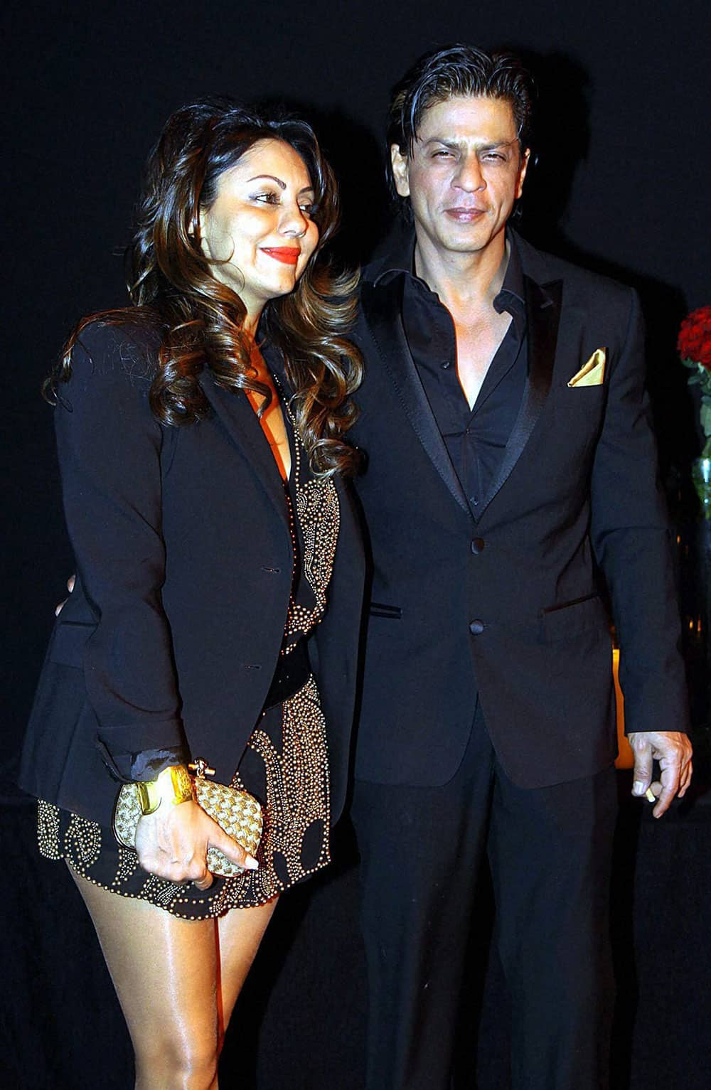 Bollywood actor Shah Rukh Khan poses with his wife Gauri Khan as they arrive to attend a party hosted by actress Deepika Padukone in Mumbai.