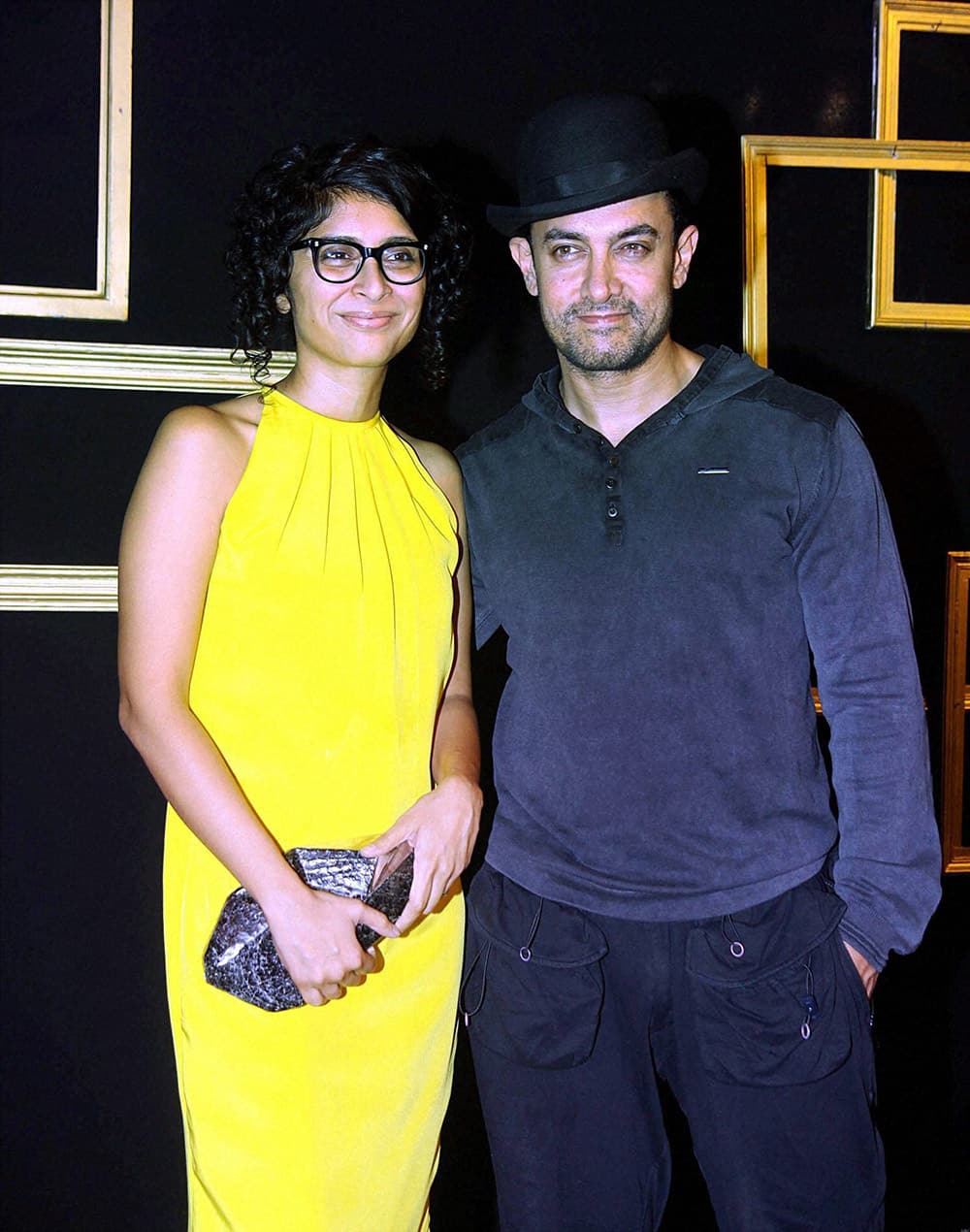 Bollywood actor Aamir Khan poses with his wife Kiran Rao as they arrive to attend a party hosted by actress Deepika Padukone in Mumbai.