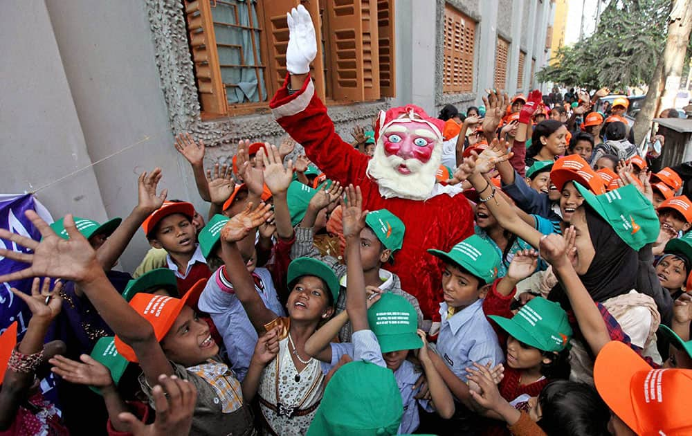 A Santa Claus entertains slum children during a Christmas celebration at Mother House in Kolkata.