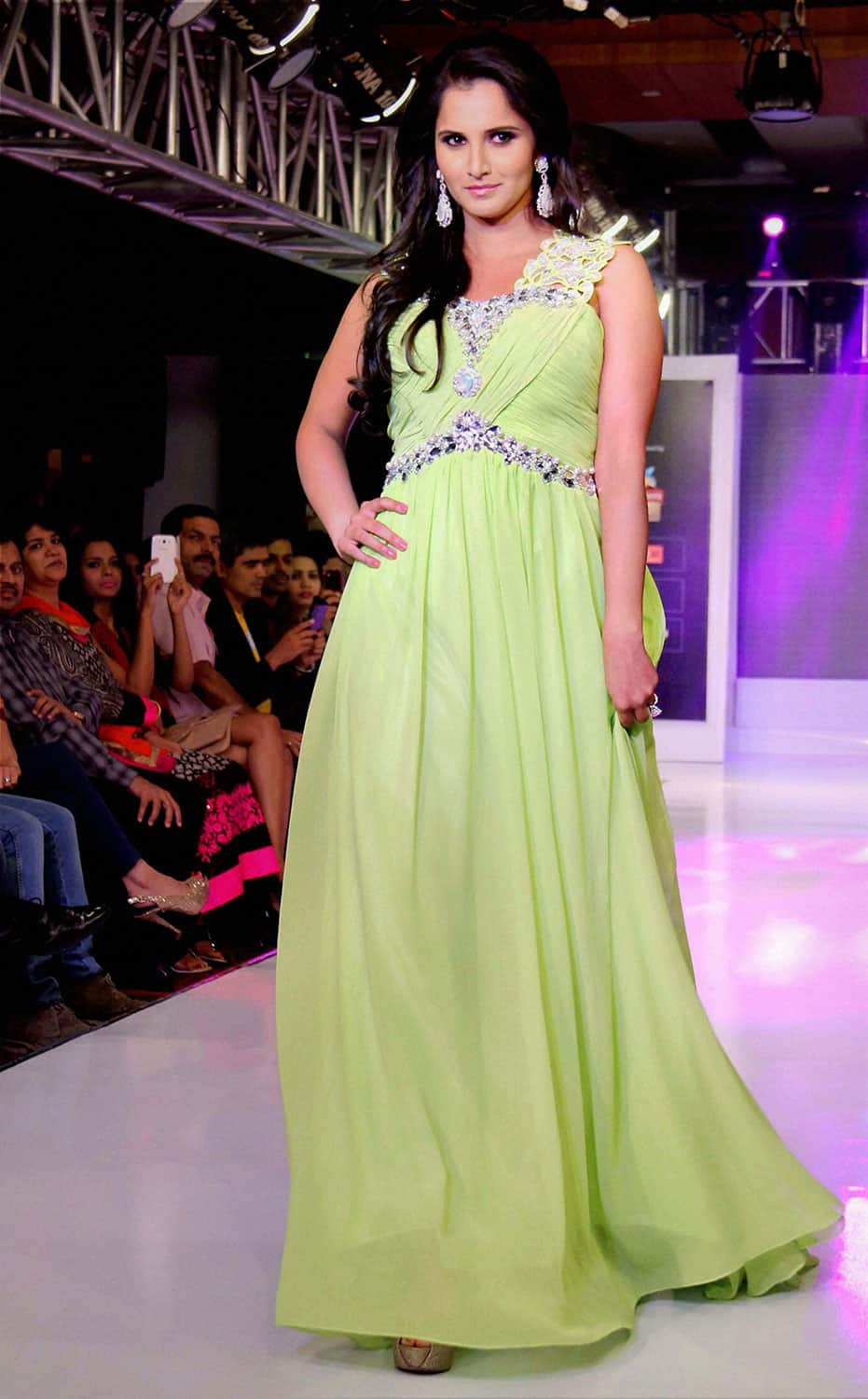 Indian tennis ace Sania Mirza walks the ramp with designer Shivali Singh on the fourth day of the Hyderabad International Fashion Week, in Hyderabad.