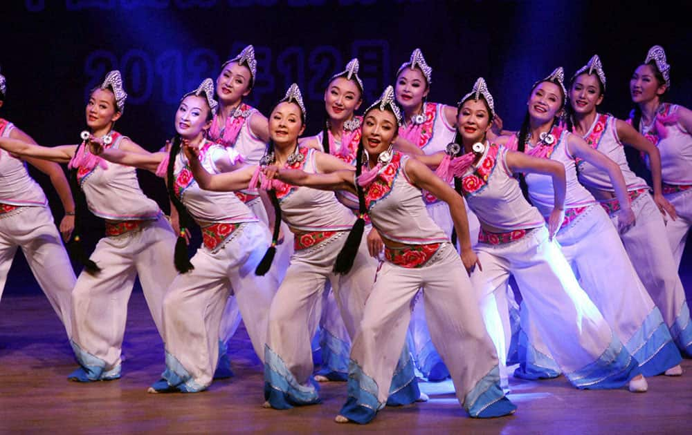 Chinese artists perform during an event in connection with Christmas and New Year celebrations in Kolkata.