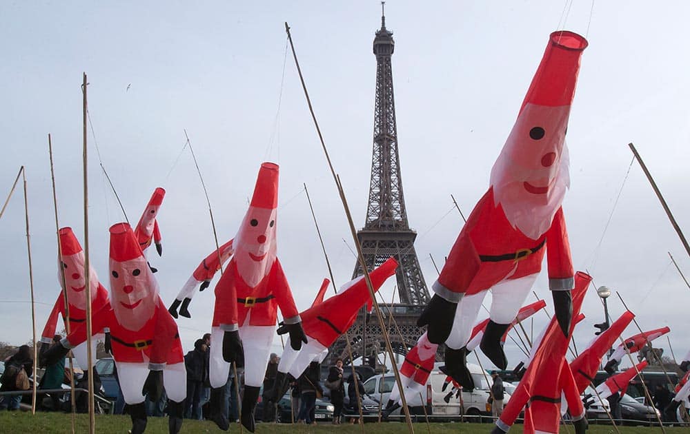 Santa Claus wind socks fly in the wind at a Christmas market at the Trocadero gardens, near the Eiffel Tower in Paris.