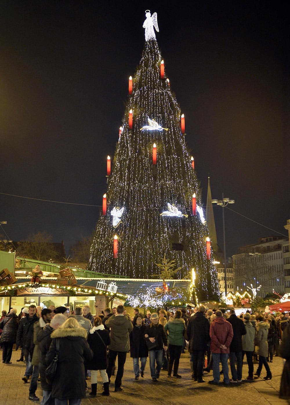 Germany's biggest Christmas tree shines in the center of a Christmas market in Dortmund, Germany.