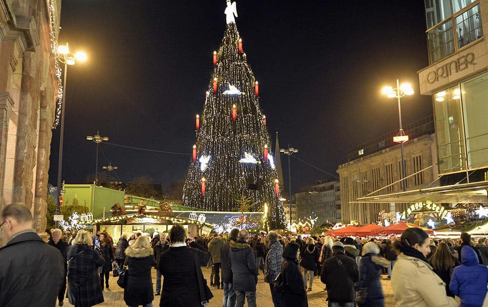 Germany's biggest Christmas tree shines in the center of a Christmas market in Dortmund, Germany.