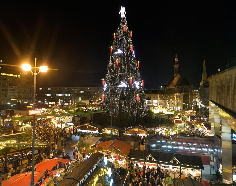 Germany's biggest Christmas tree shines in the center of a Christmas market in Dortmund, Germany.