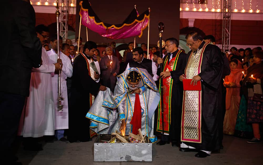 Bishop Jacob Mor Barnabas, centre, performs Syro-Malankara Rite, a ritual, at the Sacred Heart's Cathedral on Christmas Eve in New Delhi.