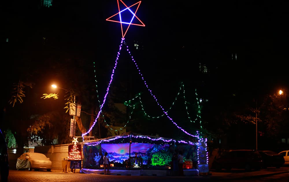 A crib is lit up with lights on Christmas eve in Mumbai.