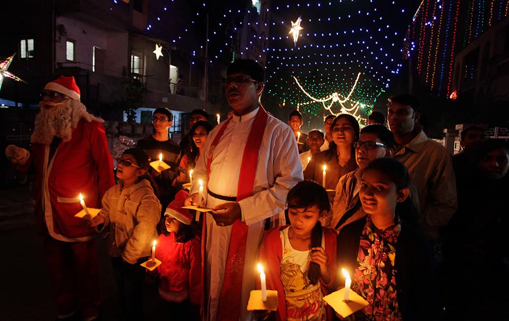 Christians hold candles ahead of Christmas in Ahmadabad.