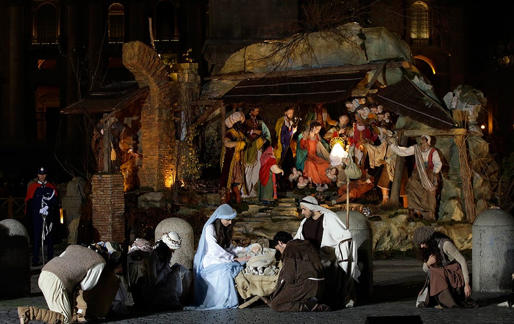 Dancers impersonating Mary, Joseph and St. Francis perform in front of the Nativity scene unveiled in St.Peter's Square at the Vatican.