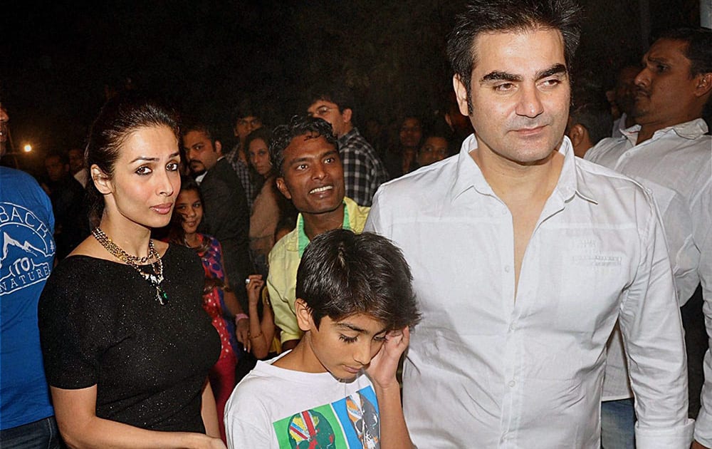 Malaika Arora Khan with her filmmaker husband Arbaaz Khan (R) and son Arhaan Khan attend the Midnight Mass on Christmas Eve at a church in Mumbai.