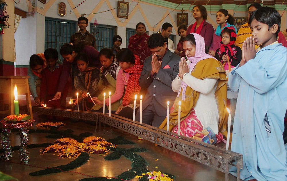 Devotees pray at a church on the occasion of Christmas in South Dinajpur district of West Bengal.