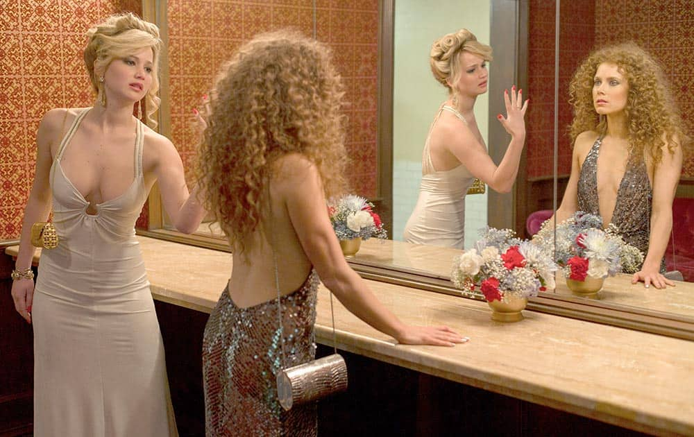 This photo released by Sony Pictures shows Jennifer Lawrence, left, as Rosalyn Rosenfeld, and Amy Adam as Sydney Prosser in Columbia Pictures' 'American Hustle.'