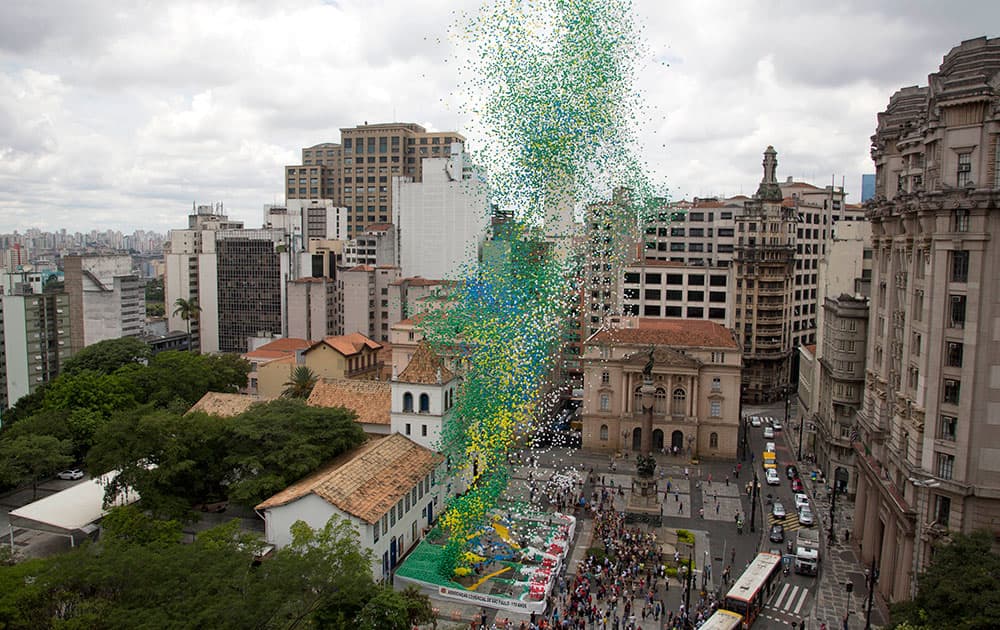Members of Sao Paulo's Commerce Association release thousands of balloons with the color of the Brazilian flag to celebrate the end of the year in downtown Sao Paulo, Brazil.