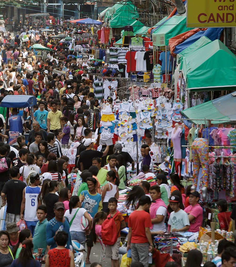 Hundreds of shoppers crowd Manila's commercial district of Divisoria to do last-minute shopping for the traditional celebration of welcoming the new year, in the Philippines.