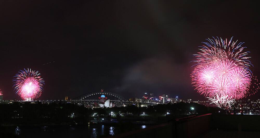 Fireworks explode near the Harbor Bridge and the Opera House during New Year's Eve celebrations in Sydney.