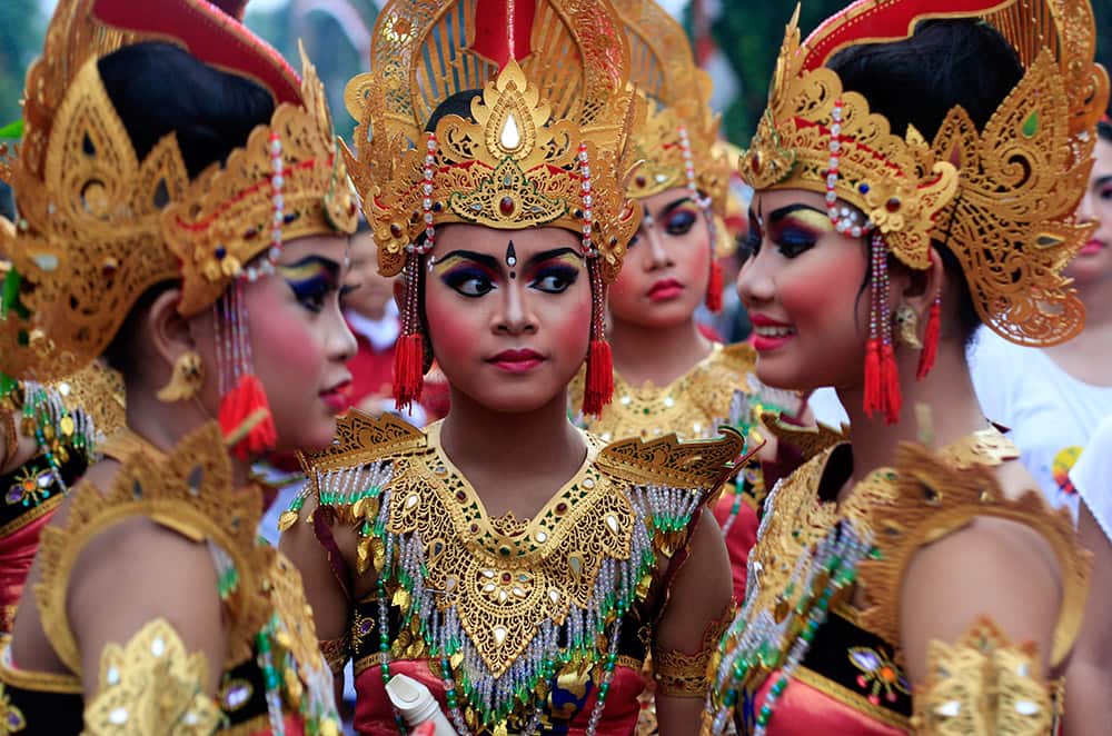 Balinese girls in traditional costumes gather during a parade for this year's last sundown in Bali island, Indonesia on New Year's Eve.