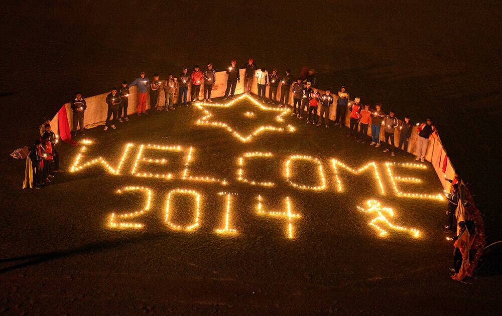 Sportmen light candles to celebrate on the eve of New Year at Madan Mohan Malviya Stadium in Allahabad.