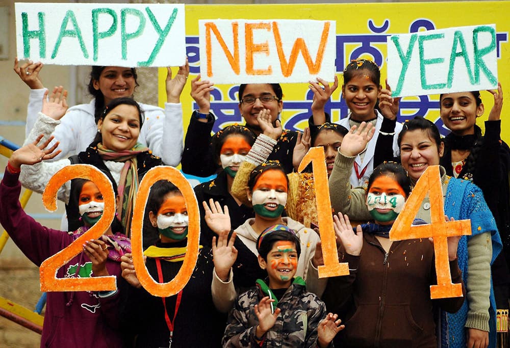 Girls painted their faces as part of their new year's celebration on the eve of New Year in Patiala.