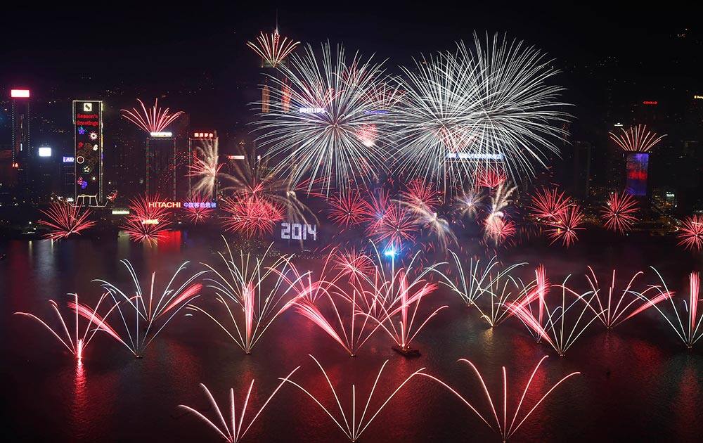Fireworks explode at the Hong Kong Convention and Exhibition Centre over the Victoria Harbor during New Year's Eve to celebrate the start of 2014 in Hong Kong.