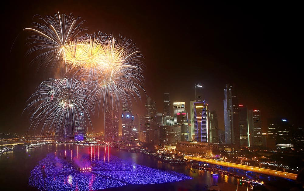 Fireworks explode over the financial district at midnight, Wednesday, Jan. 1, 2014 in Singapore.