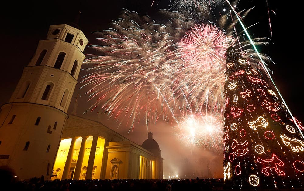 Fireworks light the sky above the Cathedral Square in Vilnius, Lithuania shortly after midnight during the New Year's Eve celebrations.