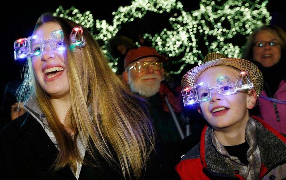Georgia Woodcock, left, of Voluntown, Conn., and her brother Lucas take part in New Year's Eve celebrations in Boston.