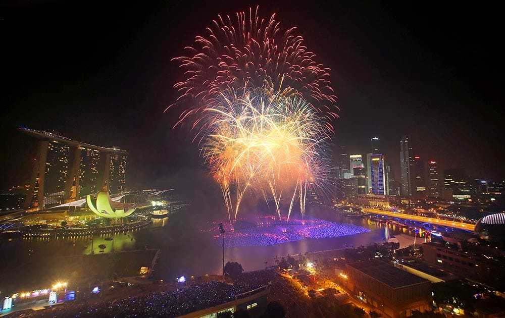 Fireworks explode over the financial district at midnight, in Singapore. Celebrations started on New Year's Eve where concerts were held and thousands gathered on the streets to usher in the Year 2014.