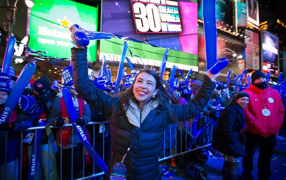 Betsy Bryant, of Nashville, dances in the buffer beside the performance stage during the New Year's Eve celebrations in Times Square, in New York.