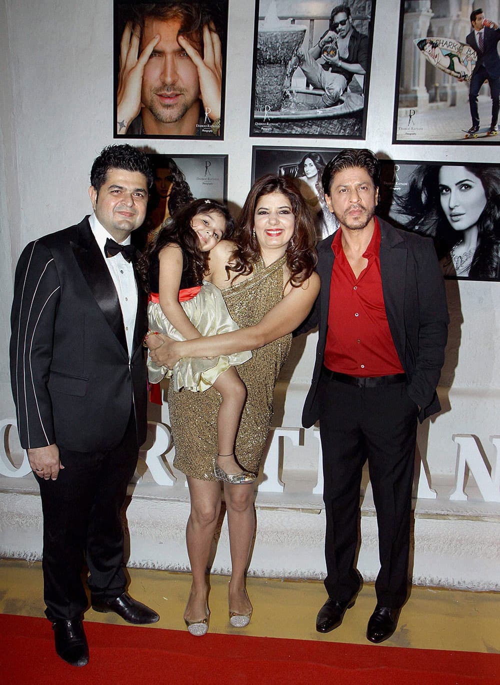 Bollywood superstar Shah Rukh Khan with photographer Dabboo Ratnani and his family at the launch of Ratnani's annual Bollywood calendar in Mumbai.