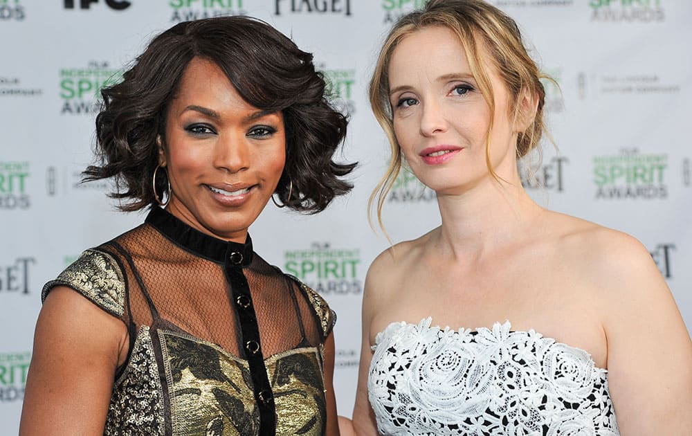 Angela Bassett, left, and Julie Delpy stand for a photo the 2014 Film Independent Filmmaker Grant and Spirit Awards Nominees Brunch in West Hollywood, Calif.