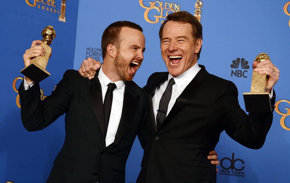 Aaron Paul, left, and Bryan Cranston pose in the press room with the award for best television series - drama for `Breaking Bad` at the 71st annual Golden Globe Awards.